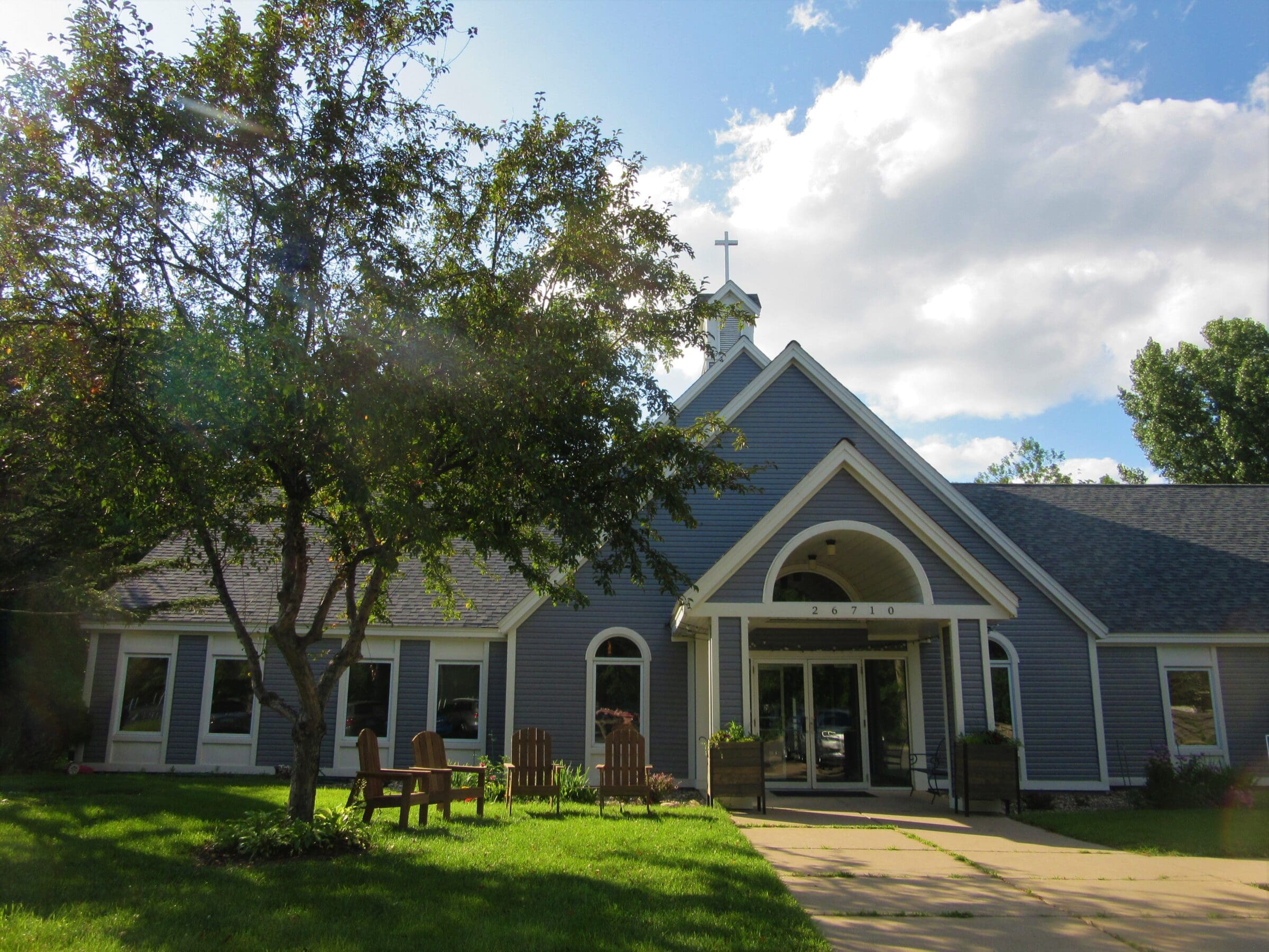 Off-angle of the front entrance of the church with a welcome banner hanging over the doors